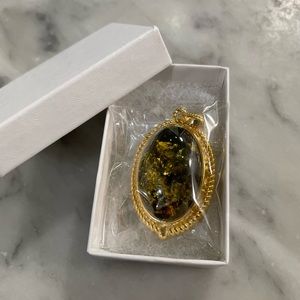 Gold and green necklace with large stone pendant